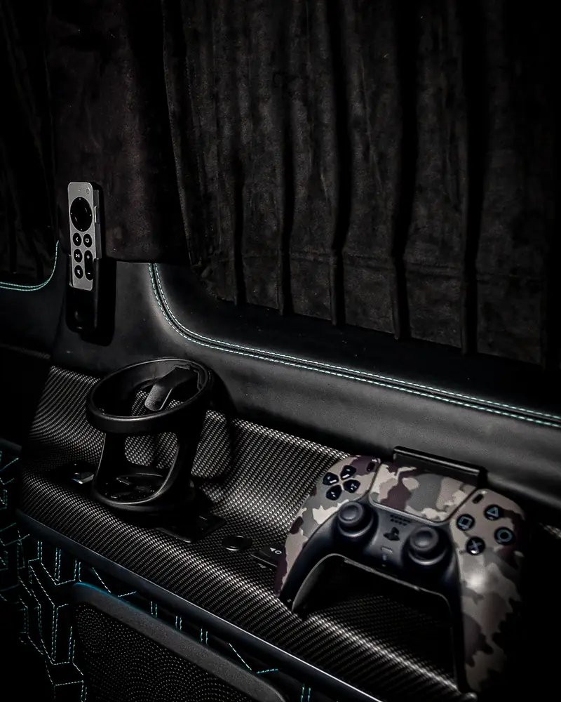Carbon-fibre console with gaming controller and ambient stitching